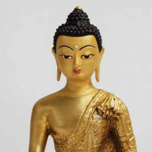 Buddha-ansigt i messing fra Nepal – nærbillede af håndlavede detaljer